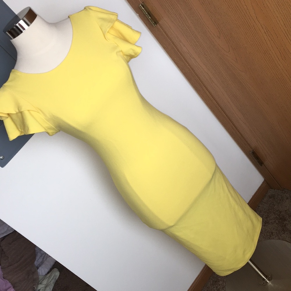 a yellow dress with ruffle arms